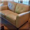 F05. One of a pair of matching Violino leather loveseats. 61"h x 36"w x 18"d 